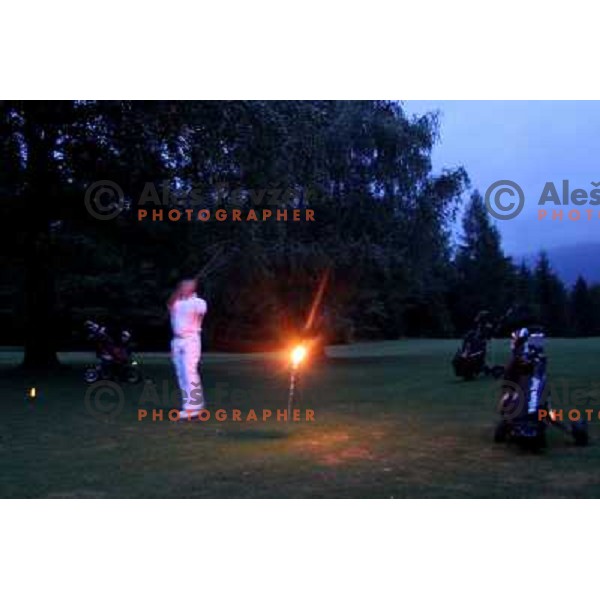 Night golf tournament with glowing golf balls at King\'s golf course at Bled, Slovenia on July 15, 2011 