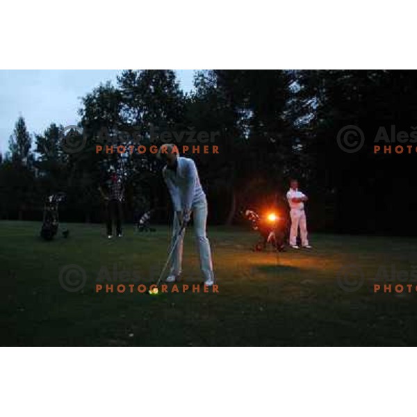 Night golf tournament with glowing golf balls at King\'s golf course at Bled, Slovenia on July 15, 2011 