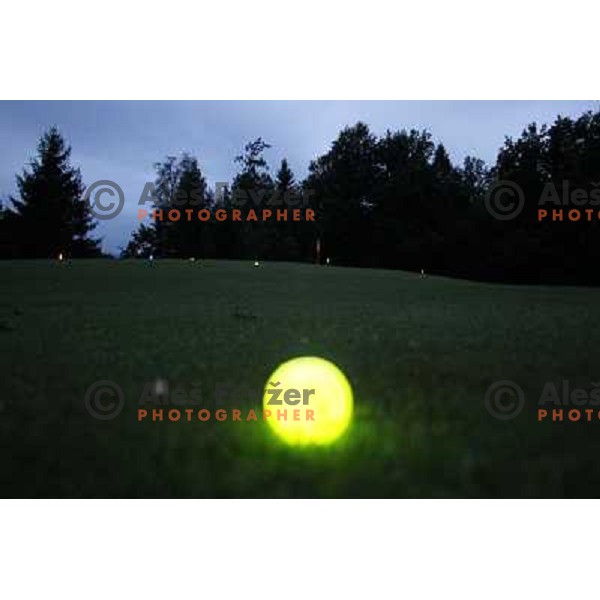 Night golf tournament with glowing golf balls at King\'s golf course at Bled, Slovenia on July 15, 2011 