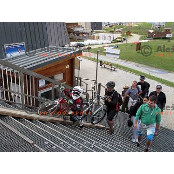 French family with 7 years old son enjoy MTB park in Alpe d\'Huez ski resort, France on August 3, 2011 