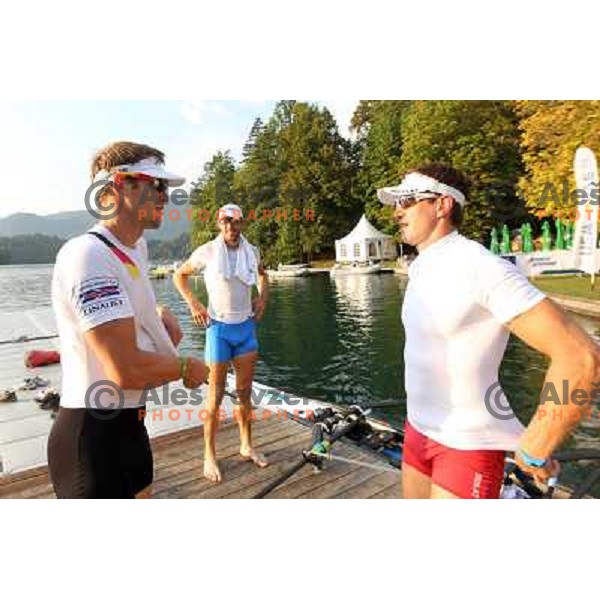 Marcel Hacker of Germany talks to Luka Spik and Iztok Cop of Slovenia during practice session at Lake Bled a day before first races at 2011 World Rowing Championships at Bled, Slovenia on August 28,2011 