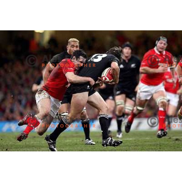 Stephen Jones tries to stop Conrad Smith at rugby match between Wales and New Zealand at Millennium Stadium, Cardiff, Wales on November 25, 2006. New Zealand won 45:10
