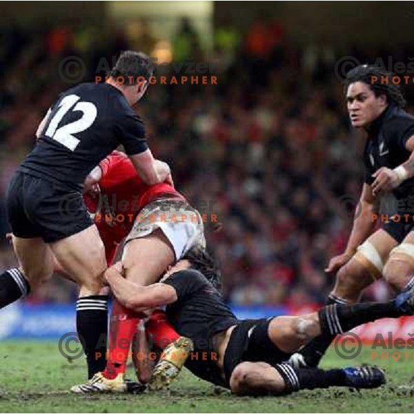 Luke McAlister (12) and Dan Carter try to stop welsh player at rugby match between Wales and New Zealand at Millennium Stadium, Cardiff, Wales on November 25, 2006. New Zealand won 45:10