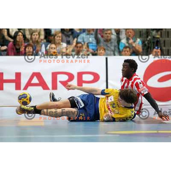 Sebastjan Skube of Cimos Koper and Luc Abalo of Atletico Madrid during handball match RK Cimos Koper (Slovenia) and BM Atletico Madrid (Spain) in VELUX EHF Champions league 2011-2012, played in Bonifika Hall, Koper, Slovenia on April 22, 2012 