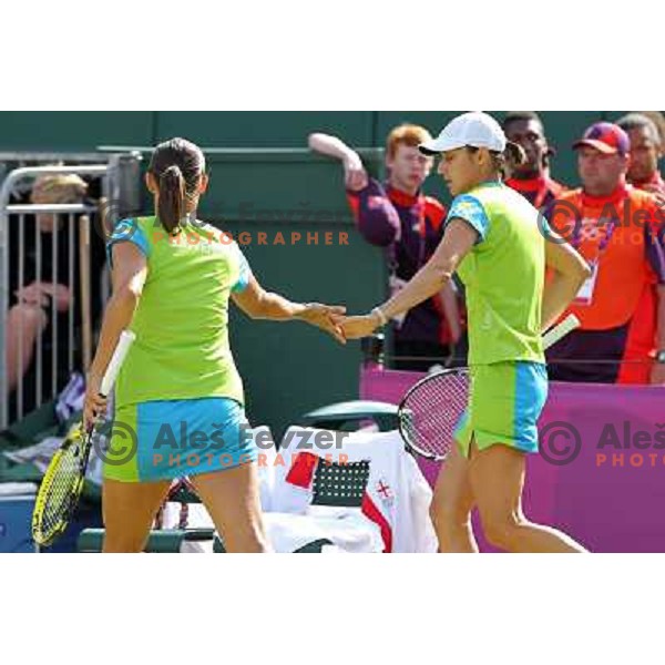 Katarina Srebotnik and Andreja Klepac of Slovenia in action in first round of women\'s doubles tennis tournament in Wimbledon during London 2012 Summer Olympic Games, Great Britain on July 30, 2012 