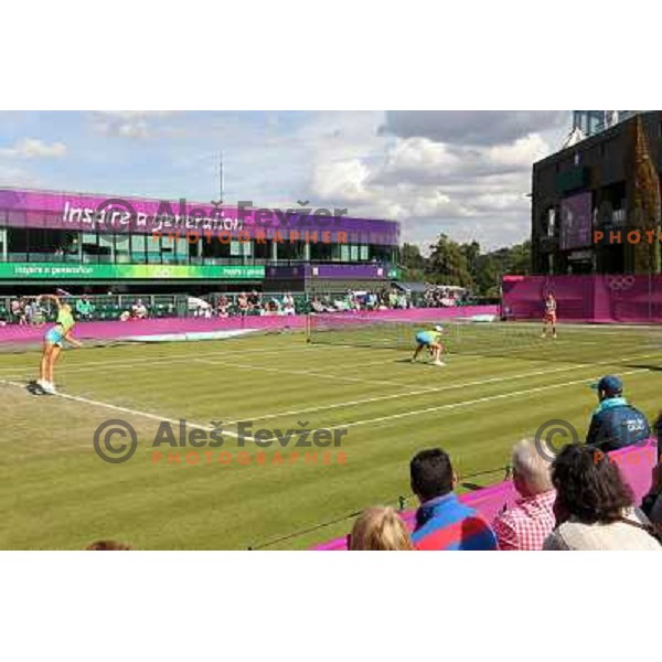 Katarina Srebotnik and Andreja Klepac of Slovenia in action in first round of women\'s doubles tennis tournament in Wimbledon during London 2012 Summer Olympic Games, Great Britain on July 30, 2012 