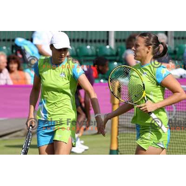 Katarina Srebotnik and Andreja Klepac of Slovenia in action in first round of women\'s doubles tennis tournament in Wimbledon during London 2012 Summer Olympic Games, Great Britain on July 30, 2012 