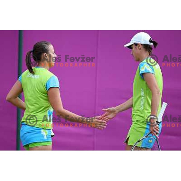 Katarina Srebotnik and Andreja Klepac of Slovenia in action in first round of women\'s doubles tennis tournament in Wimbledon during London 2012 Summer Olympic Games, Great Britain on July 30, 2012 