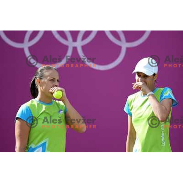 Katarina Srebotnik and Andreja Klepac of Slovenia in action in first round of women\'s doubles tennis tournament in Wimbledon during London 2012 Summer Olympic Games, Great Britain on July 30, 2012 