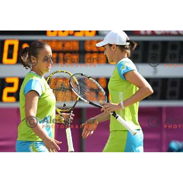 Katarina Srebotnik and Andreja Klepac of Slovenia in action in first round of women\'s doubles tennis tournament in Wimbledon during London 2012 Summer Olympic Games, Great Britain on July 30, 2012 