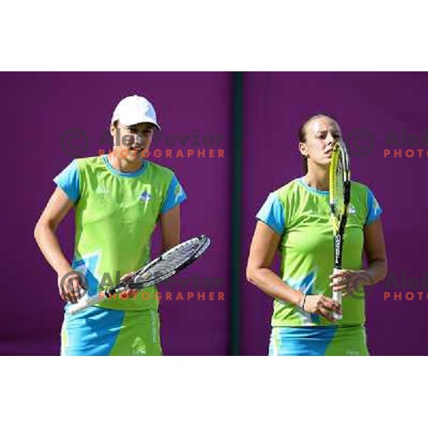 Katarina Srebotnik and Andreja Klepac of Slovenia in action in first round of women\'s doubles tennis tournament in Wimbledon during London 2012 Summer Olympic Games, Great Britain on July 30, 2012 