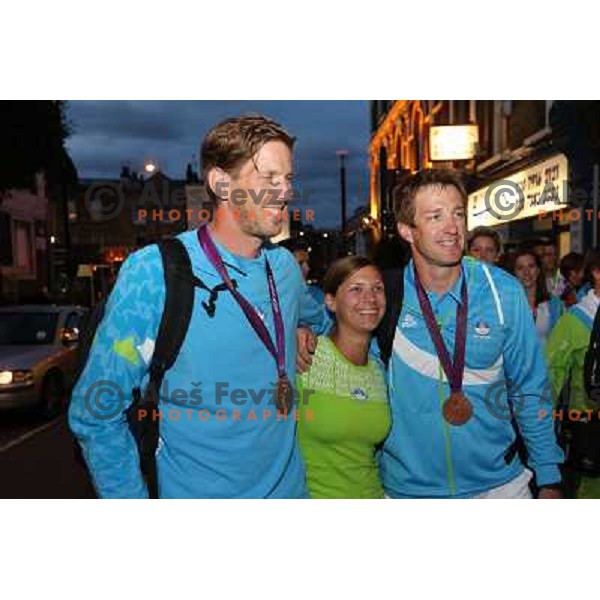 Iztok Cop and Luka Spik of Slovenia, Olympic bronze medalists in double sculls at Eton Dorney celebrate their medal with fans in Slovenia pub in Camden during London 2012 Summer Olympic games, Great Britain on 2nd of August 2012 