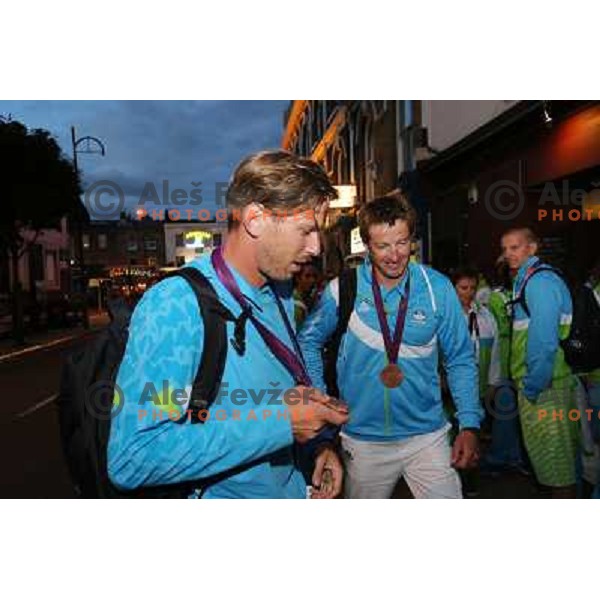 Iztok Cop and Luka Spik of Slovenia, Olympic bronze medalists in double sculls at Eton Dorney celebrate their medal with fans in Slovenia pub in Camden during London 2012 Summer Olympic games, Great Britain on 2nd of August 2012 