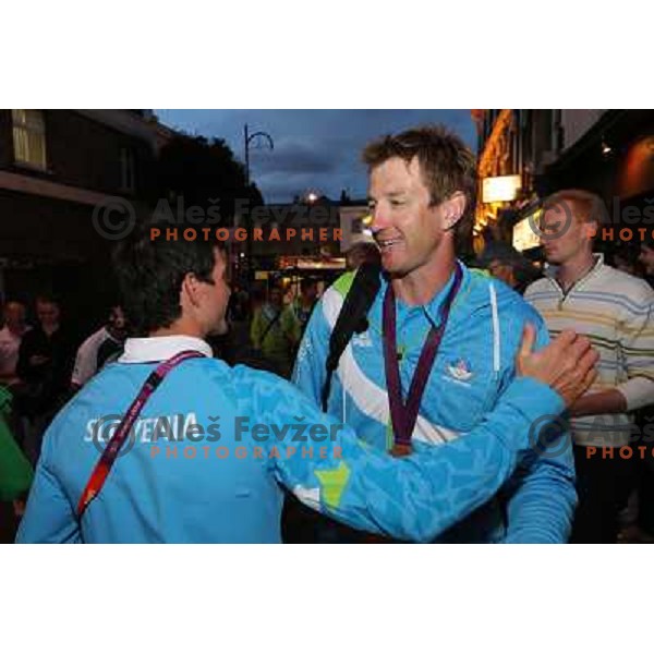 Peter Kauzer and Iztok Cop of Slovenia, Olympic bronze medalist in double sculls at Eton Dorney celebrate their medal with fans in Slovenia pub in Camden during London 2012 Summer Olympic games, Great Britain on 2nd of August 2012 