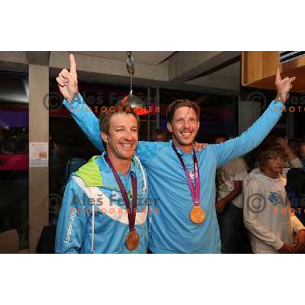 Iztok Cop and Luka Spik of Slovenia, Olympic bronze medalists in double sculls at Eton Dorney celebrate their medal with fans in Slovenia pub in Camden during London 2012 Summer Olympic games, Great Britain on 2nd of August 2012 