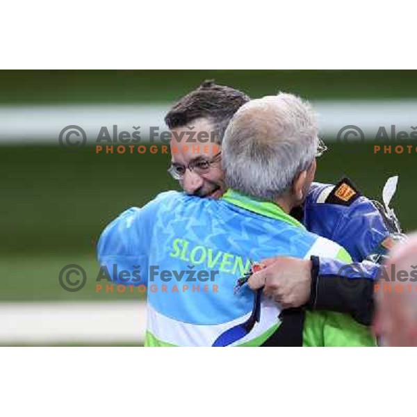 Coach Lojze Mikolic and Rajmond Debevec of Slovenia, olympic bronze medalist in men\'s 50 m Rifle Prone shooting competition at Royal Artillery Barracks, London 2012 Olympic games, Great Britain on August 3, 2012 