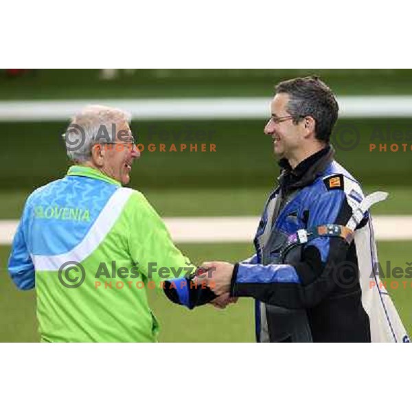 Coach Lojze Mikolic and Rajmond Debevec of Slovenia, olympic bronze medalist in men\'s 50 m Rifle Prone shooting competition at Royal Artillery Barracks, London 2012 Olympic games, Great Britain on August 3, 2012 