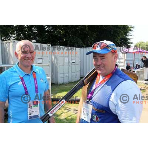 Coach Nikolaj Mejas and Bostjan Macek of Slovenia who competes in trap at shooting range of Royal Artillery Barracks during London 2012 Olympic games on August 6, 2012 