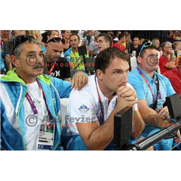 Khalid Nasif, Primoz Kozmus and coach Andrej Hajnsek watch Martina Ratej of Slovenia who competes in the final of women\'s javelin throw at Olympic Stadium during London 2012 Summer Olympic Games, Great Britain on August 9, 2012 