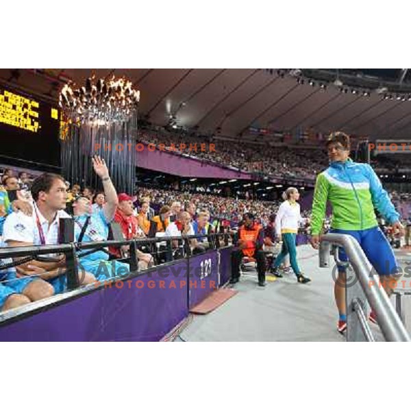 Primoz Kozmus and coach Andrej Hajnsek watch Martina Ratej of Slovenia who competes in the final of women\'s javelin throw at Olympic Stadium during London 2012 Summer Olympic Games, Great Britain on August 9, 2012 