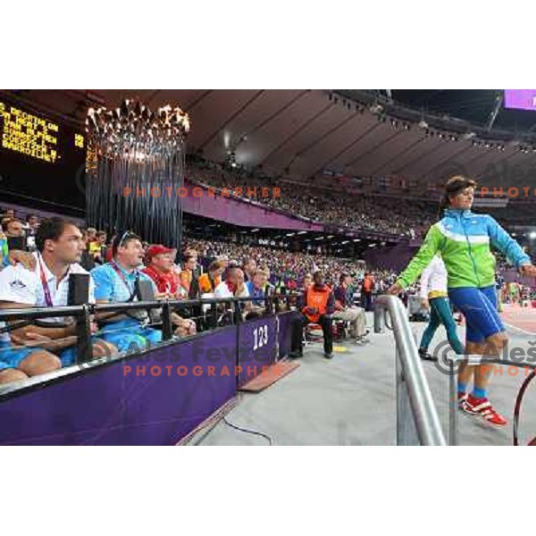 Primoz Kozmus and coach Andrej Hajnsek watch Martina Ratej of Slovenia who competes in the final of women\'s javelin throw at Olympic Stadium during London 2012 Summer Olympic Games, Great Britain on August 9, 2012 