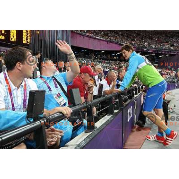 Primoz Kozmus and coach Andrej Hajnsek watch Martina Ratej of Slovenia who competes in the final of women\'s javelin throw at Olympic Stadium during London 2012 Summer Olympic Games, Great Britain on August 9, 2012 