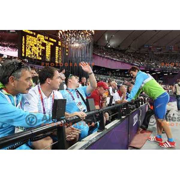 Khalid Nasif, Primoz Kozmus and coach Andrej Hajnsek watch Martina Ratej of Slovenia who competes in the final of women\'s javelin throw at Olympic Stadium during London 2012 Summer Olympic Games, Great Britain on August 9, 2012 