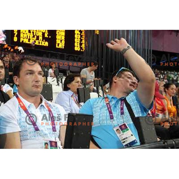 Primoz Kozmus and coach Andrej Hajnsek watch Martina Ratej of Slovenia who competes in the final of women\'s javelin throw at Olympic Stadium during London 2012 Summer Olympic Games, Great Britain on August 9, 2012 