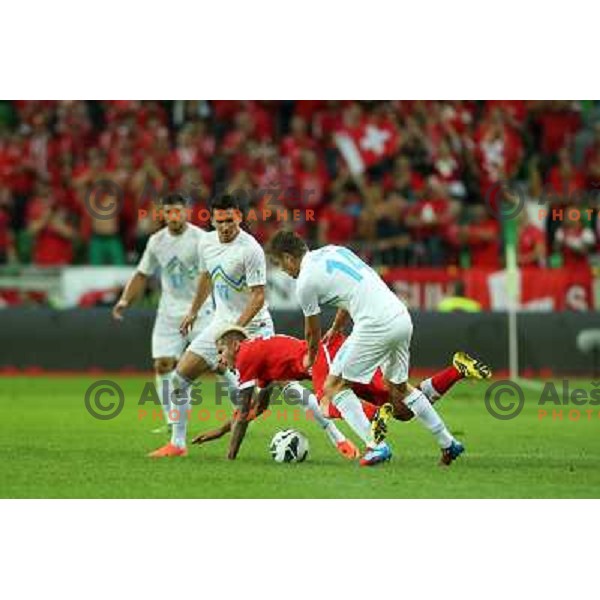 of Slovenia and of Switzerland in action during football match Slovenia-Switzerland in Qualification group E of 2014 FIFA World Cup Brasil, played in Arena Stozice, Ljubljana, Slovenia on September 7, 2012 