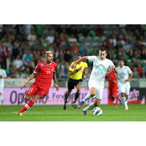 of Slovenia and of Switzerland in action during football match Slovenia-Switzerland in Qualification group E of 2014 FIFA World Cup Brasil, played in Arena Stozice, Ljubljana, Slovenia on September 7, 2012 