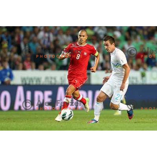 Gokhan Inler of Switzerland and Armin Bacinovic of Slovenia in action during football match Slovenia-Switzerland for FIFA 2014 World Cup Brasil Qualifiers, played in Arena Stozice, Ljubljana, Slovenia on September 7, 2012 