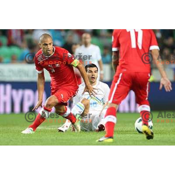 Gokhan Inler of Switzerland and Aleksander Radosavljevic of Slovenia during football match Slovenia-Switzerland for FIFA 2014 World Cup Brasil Qualifiers, played in Arena Stozice, Ljubljana, Slovenia on September 7, 2012 