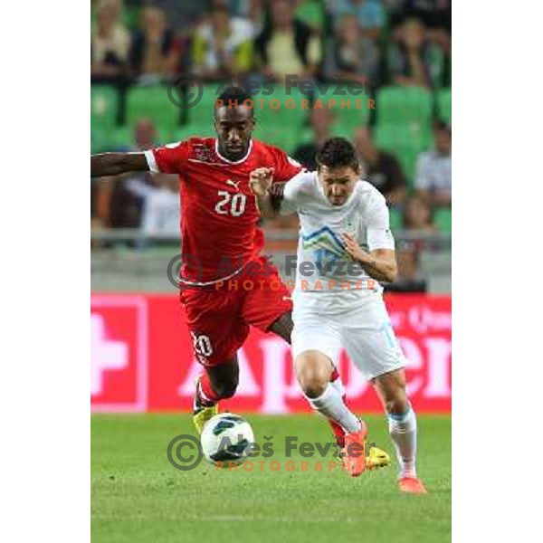Johan Djourou (SUI) and Andraz Kirm of Slovenia during football match Slovenia-Switzerland in group E in FIFA 2014 World Cup Brasil Qualifiers, played in Arena Stozice, Ljubljana, Slovenia on September 7, 2012 