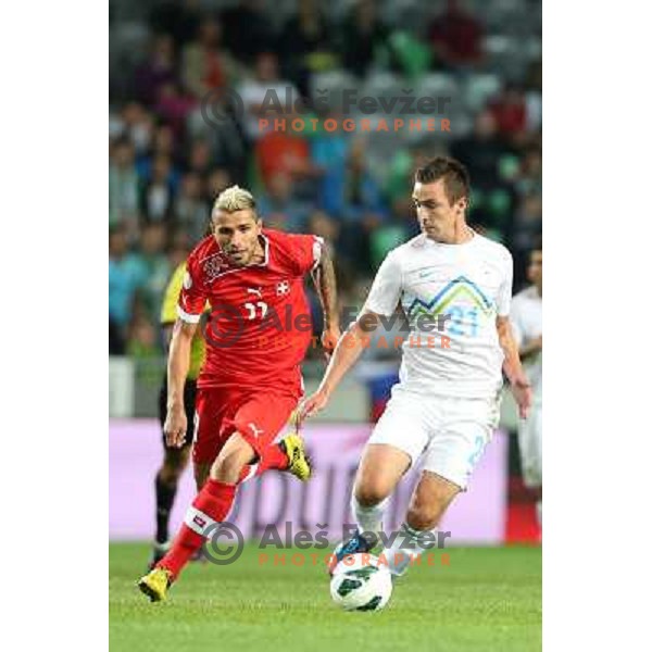 Armin Bacinovic of Slovenia and Valon Behrami of Switzerland during football match Slovenia-Switzerland in group E in FIFA 2014 World Cup Brasil Qualifiers, played in Arena Stozice, Ljubljana, Slovenia on September 7, 2012 