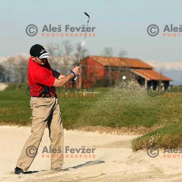 playing from the bunker at 14th hole at Grado golf course, Italy