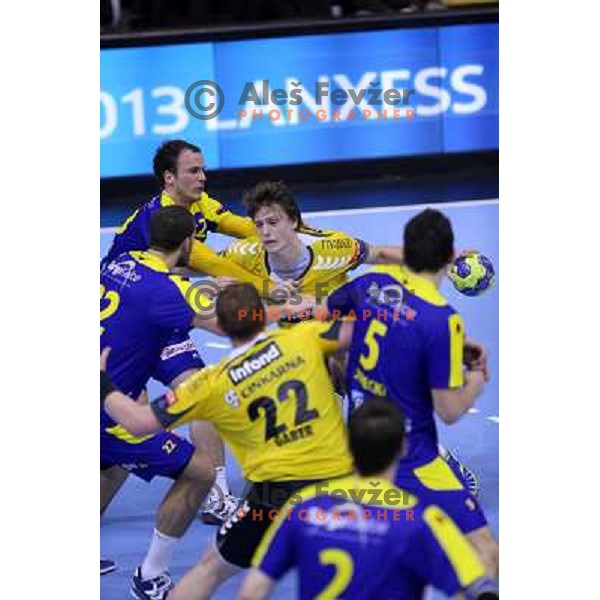 Uros Zorman of Vive Targi Kielce and Jure Dolenec of RK Gorenje Velenje in action during handball match RK Gorenje Velenje-KS Vive Targi Kielce in EHF Velux Champions league, played in Red Hall, Velenje, Slovenia on February 23, 2013 