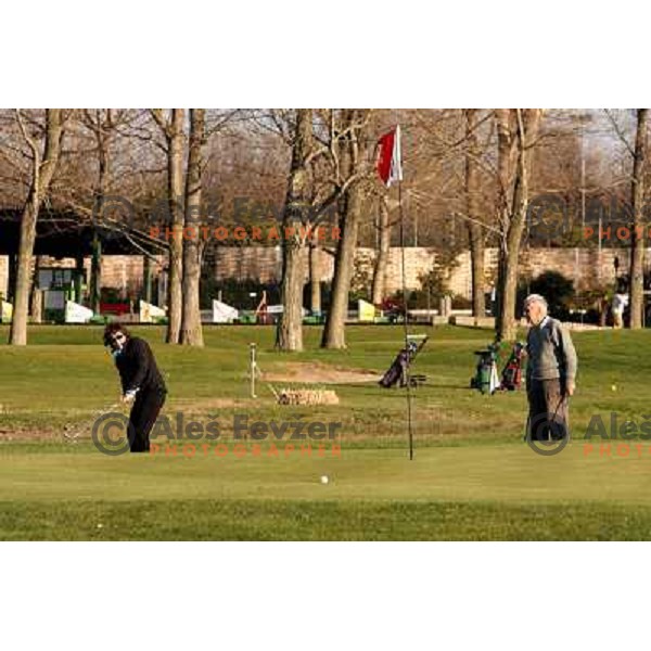 playing pitch and putt course at Grado golf course, Italy