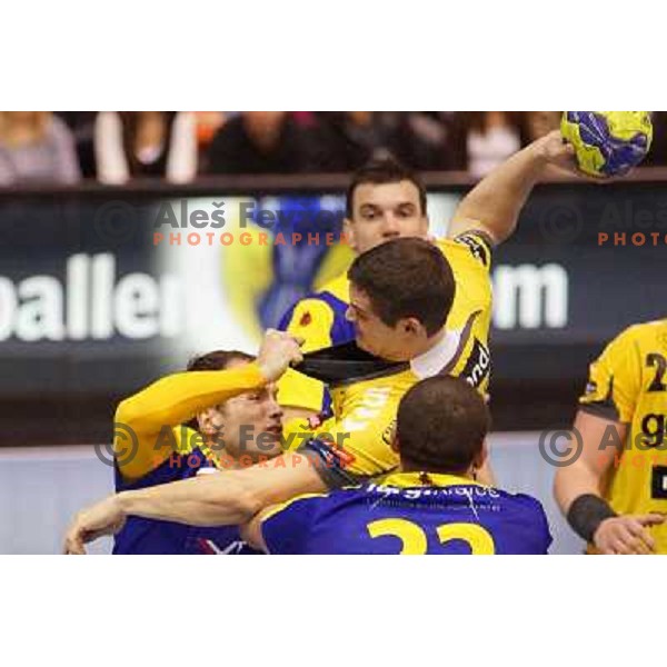 Uros Zorman of Kielce and Marko Dujmovic of RK Gorenje Velenje in action during handball match RK Gorenje Velenje-SK Vive Targi Kielce in EHF Velux Champions league, played in Red Hall, Velenje, Slovenia on February 23, 2013 