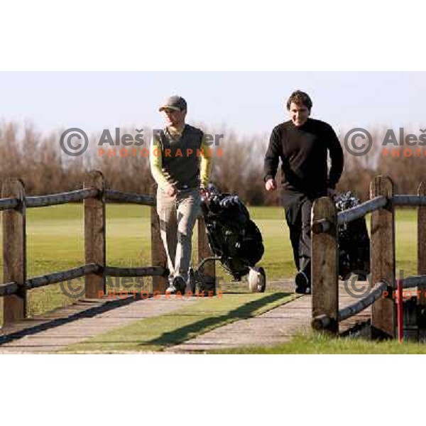 Crossing wooden bridge after playing 12th hole at Grado golf course, Italy
