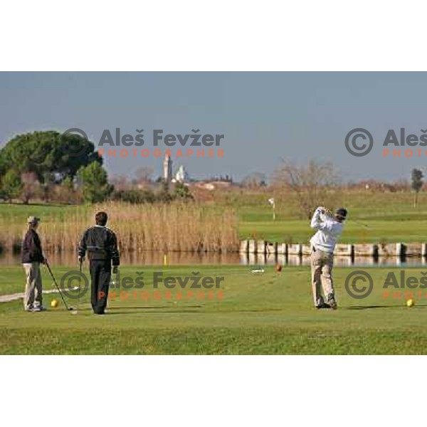 Teeing off at first hole at Grado golf course, Italy