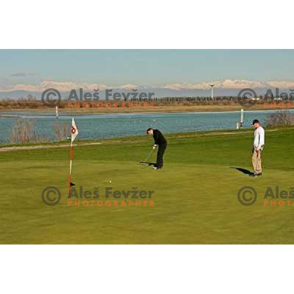 Putting from the fringe of the green at 7th hole at Grado golf course, Italy