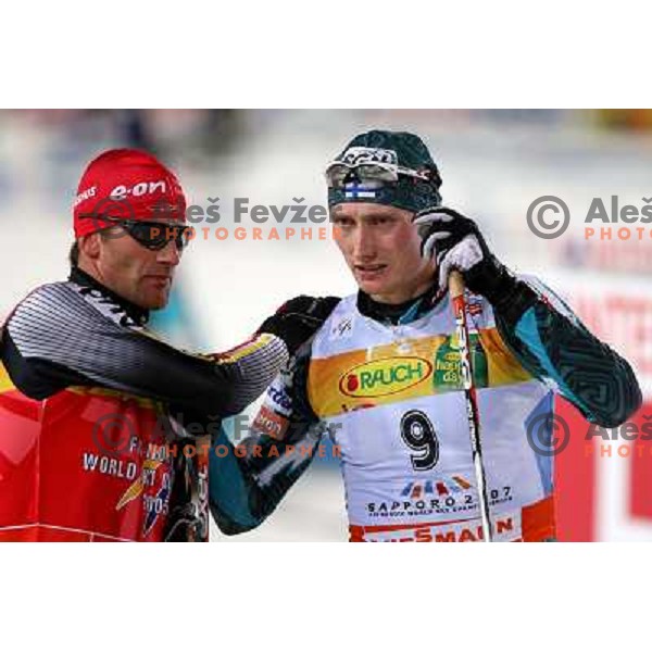 Ronny Ackermann (left) congratulate new world champion Hannu Manninen at Nordic combined 7.5km Sprint race at FIS Nordic World SKI Championships 2007 in Sapporo, Japan