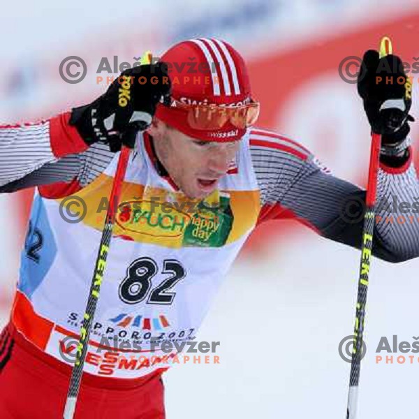 Andrea Bundi racing in snow storm at Cross Country 15 km individual race at FIS Nordic Ski WC Sapporo, Japan
