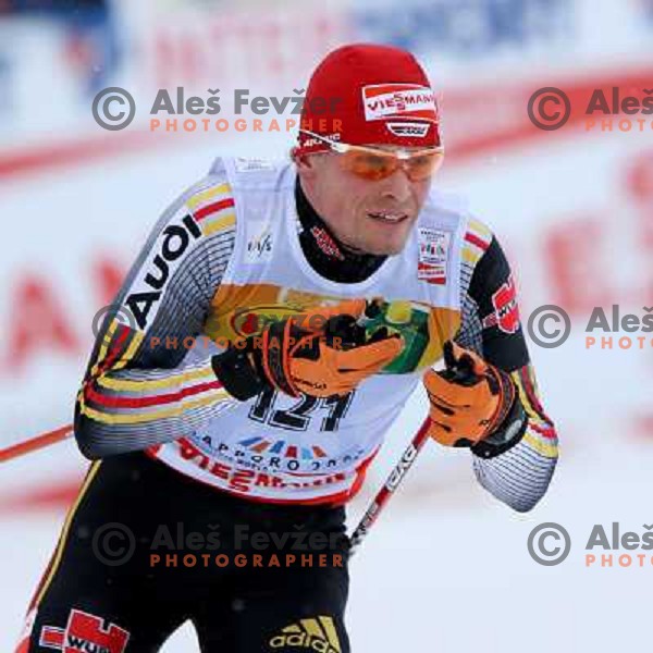 Tobias Angerer racing in snow storm at Cross Country 15 km individual race at FIS Nordic Ski WC Sapporo, Japan