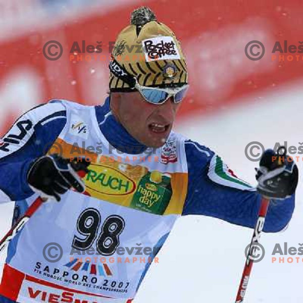 Giorgio Di Centa racing in snow storm at Cross Country 15 km individual race at FIS Nordic Ski WC Sapporo, Japan