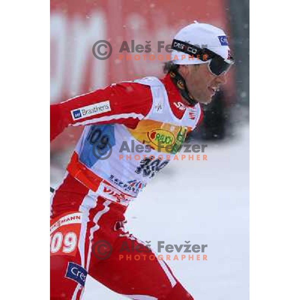 Ole Einar Bjoerndalen racing in snow storm at Cross Country 15 km individual race at FIS Nordic Ski WC Sapporo, Japan