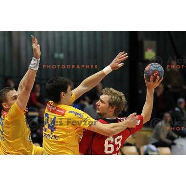Nemanja Zelenovic of Celje Pivovarna Lasko and Miha Tomsic of Slovan in action during handball match Slovan - Celje PL. in 1. NLB leasing liga, played in Kodeljevo Hall, Ljubljana, Slovenia on November 27, 2013 