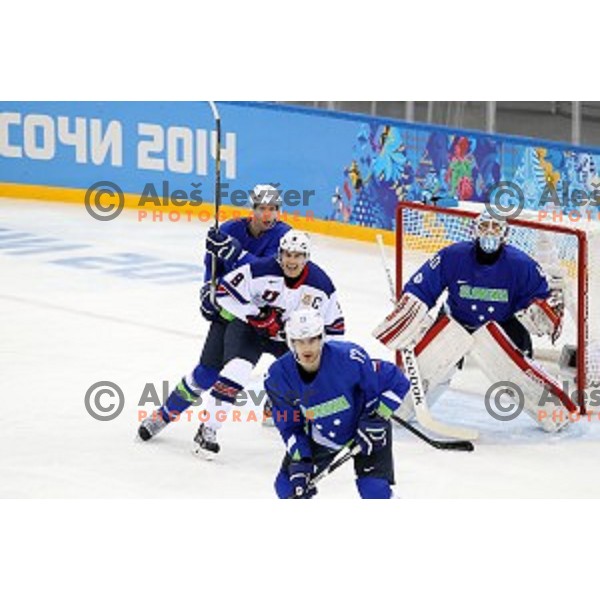 Zach Parise of USA and Andrej Tavzelj, Luka Gracnar of Slovenia in action during Preliminary round match Slovenia-USA at Shayba Arena, Sochi 2014 Winter Olympic games, Russia on February 16, 2014