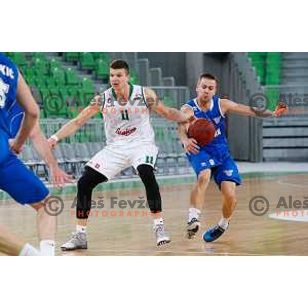 Dino Muric of Union Olimpija and Tadej Kostomaj of Rogaska in action during basketball match between Union Olimpija and Rogaska of Telemach Leauge, played in Arena Stozice, Ljubljana, Slovenia on March 19, 2014