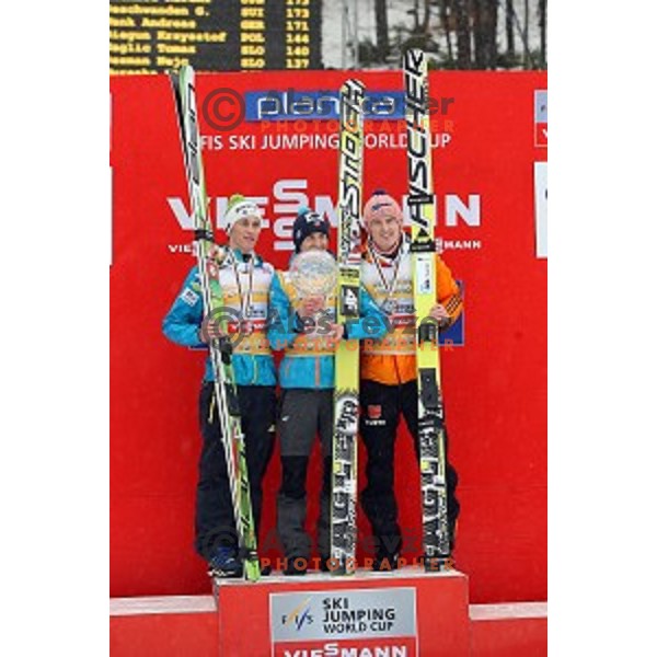 Peter Prevc of Slovenia, second place overall World Cup 2013/2014 season, winner Kamil Stoch of Poland and Severin Freund (GER) third placed in Planica, Slovenia on March 23,2014
